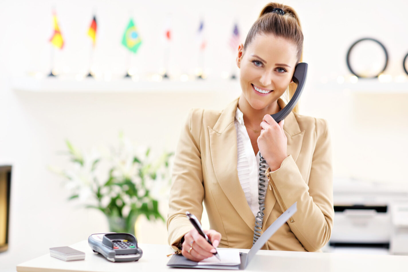happy-receptionist-working-in-hotel-2023-11-27-05-09-53-utc-scaled.jpg